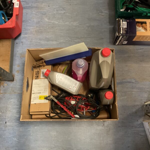 Car maintenance kit with antifreeze, brake fluid, and oil filter wrench.