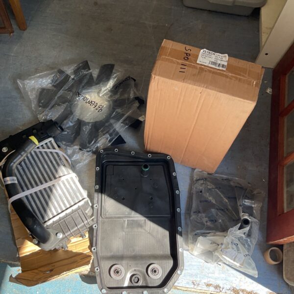 Automotive parts lot including car sump pans and intercooler.