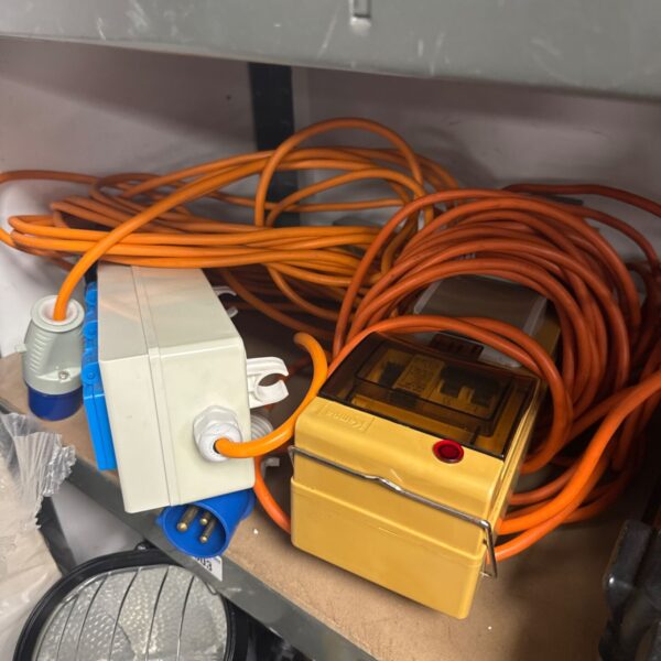 Caravan mains hookup cables with integrated circuit breakers for camping.