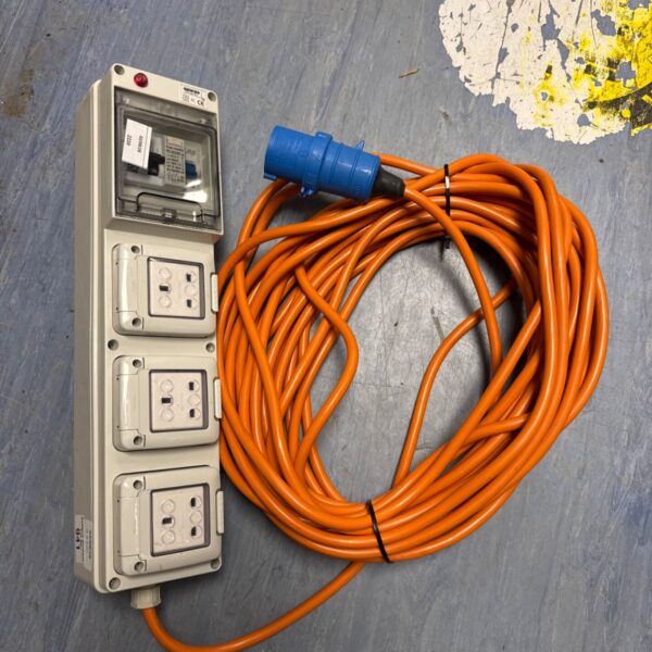 Orange caravan hookup extension cable with three sockets and breakers.