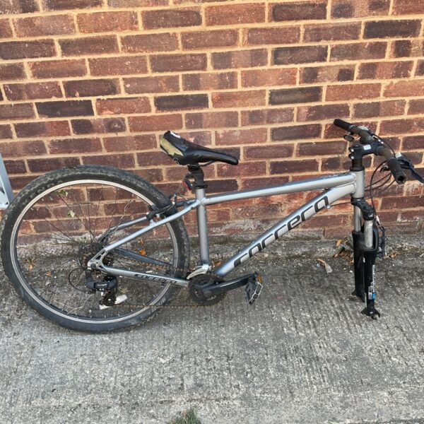 Silver Carrera Valour mountain bike missing front wheel.
