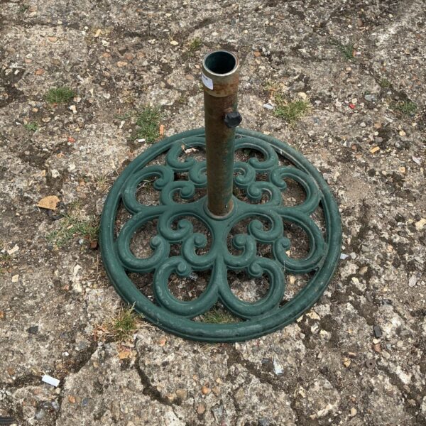 Intricate cast iron garden umbrella base for patio use.