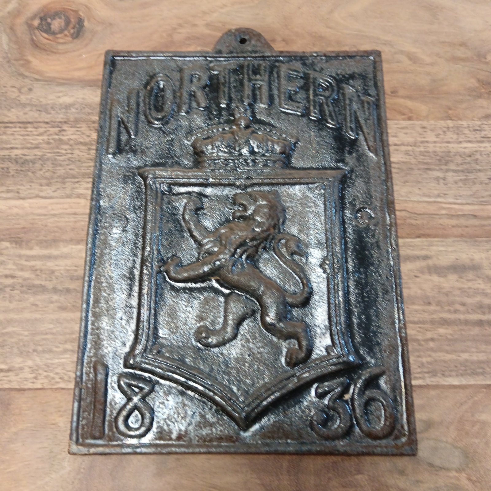 Antique cast iron Northern Railway plaque from 1836 with lion design.