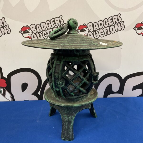 Antique cast iron pagoda lantern with weathered patina.
