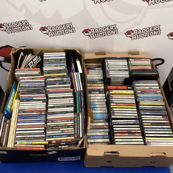 Mixed lot of CDs and cassette tapes including Mozart and Genesis.
