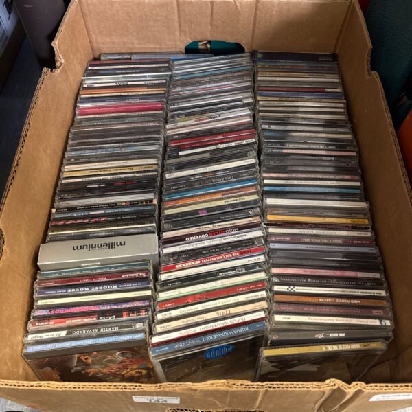 Box of assorted music CDs including Oasis, U2 and The Jam.
