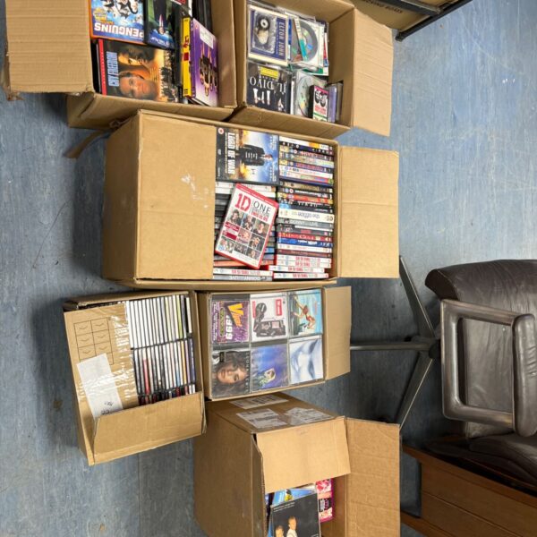 Stack of cardboard boxes filled with a CD and DVD job lot.