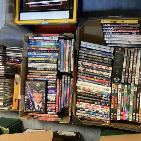 Mixed lot of CDs and DVDs including The Simpsons and Eric Clapton.