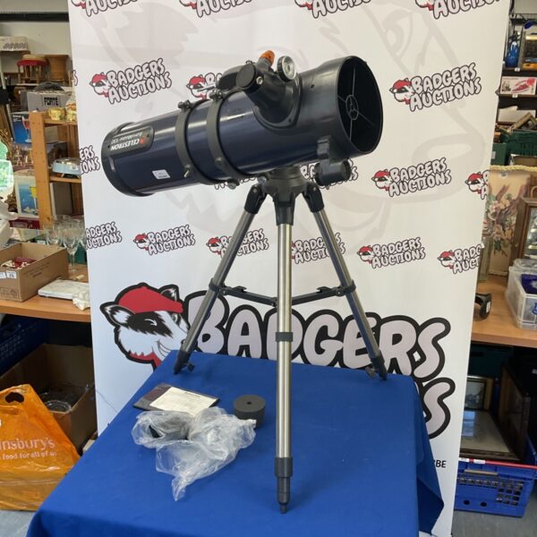 Celestron Astro Master 130 telescope on tripod for astronomy.