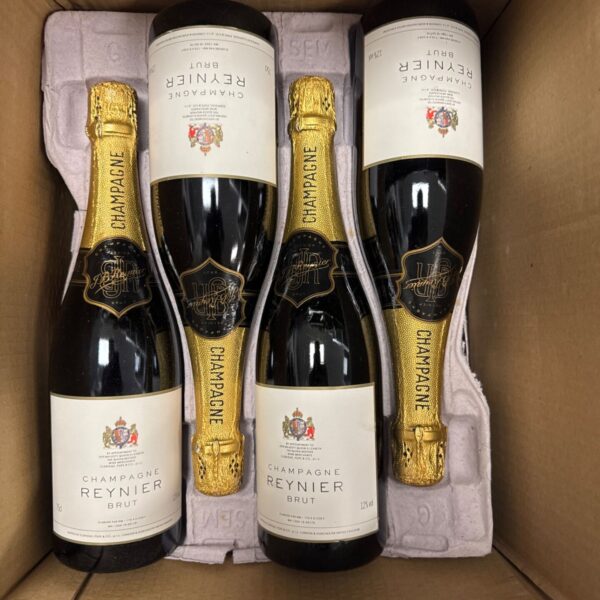 Eight bottles of Champagne Reynier Brut displayed together.