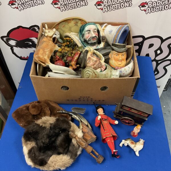 Collection of vintage character jugs and pottery items.