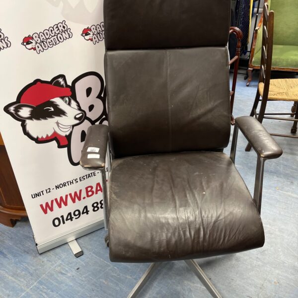 Charcoal leather office chair with five-star base and castors.