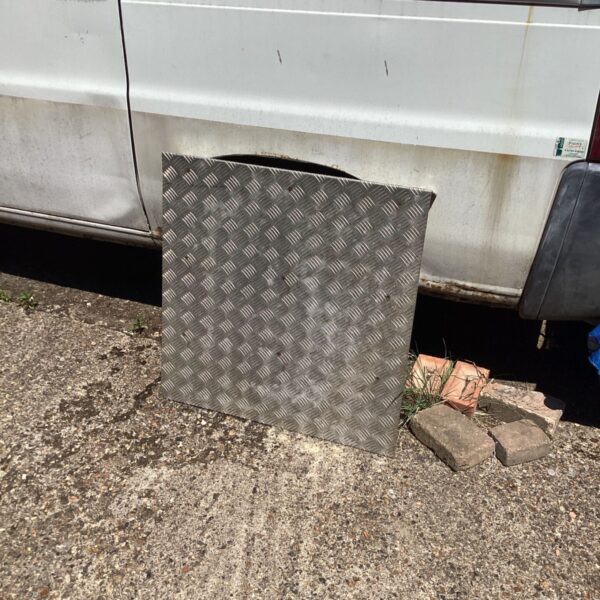 Steel checker plate ramp with diamond pattern for grip.