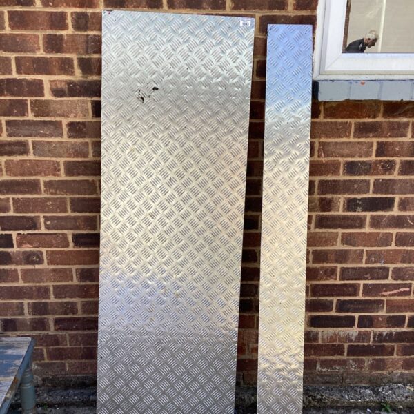 Two large chequer plate steel sheets for industrial use.
