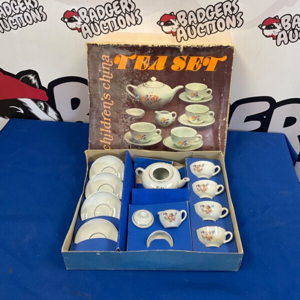 Vintage children’s china tea set with floral pattern.