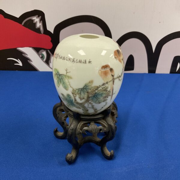 Hand-painted Chinese bird vase on a wooden pedestal.