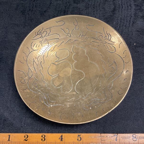 Antique Chinese brass dish with detailed dragon engraving.