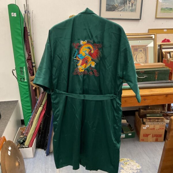 Green silk Chinese dragon robe with detailed embroidery.