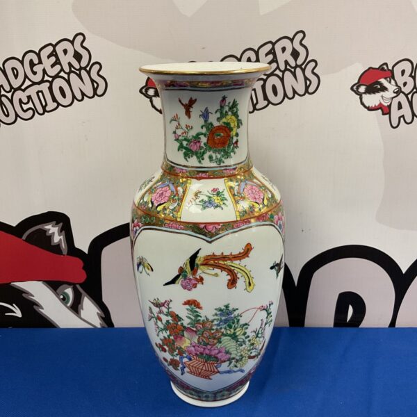 Antique Chinese Famile Rose porcelain vase with floral designs.