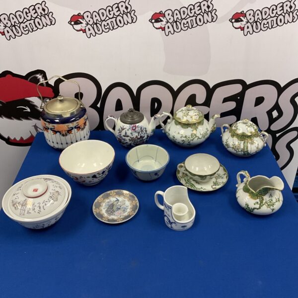 Collection of antique Chinese and Japanese porcelain including teapots and figurines.