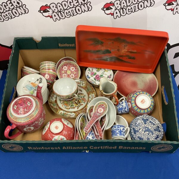 Vintage Chinese and Japanese teasets and rice bowls on a tray.