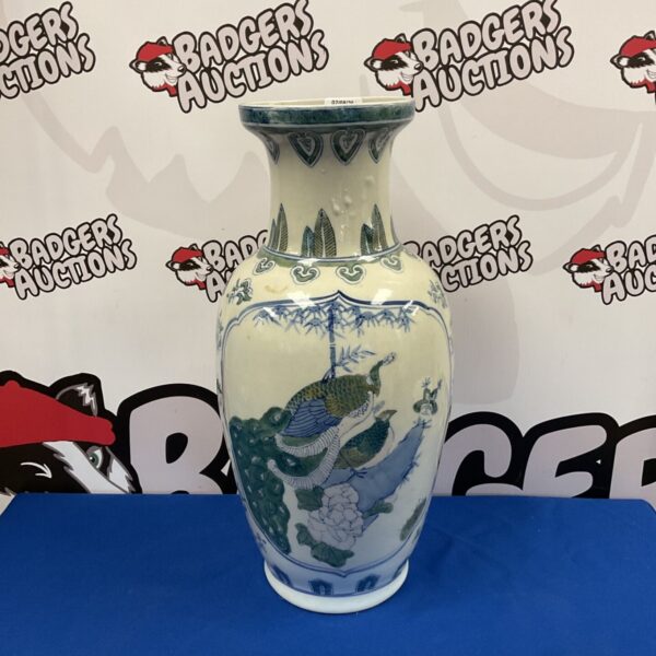 Large Chinese porcelain vase with a detailed peacock design.