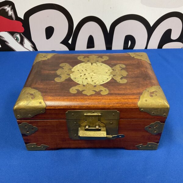 Antique Chinese wooden box with ornate brass lock and key.