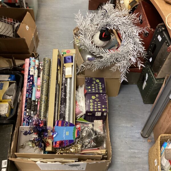 A lot of Christmas decorations including wrapping paper and ribbons.
