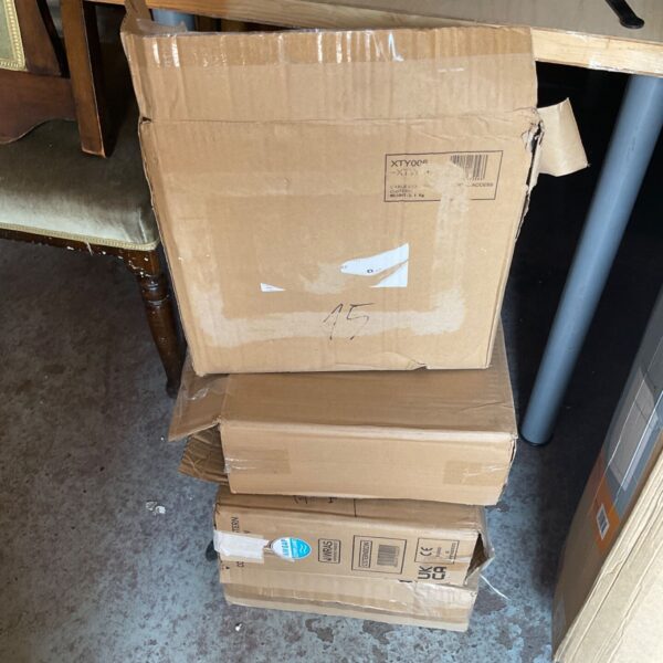 Stack of four boxed internal cisterns for toilet plumbing.
