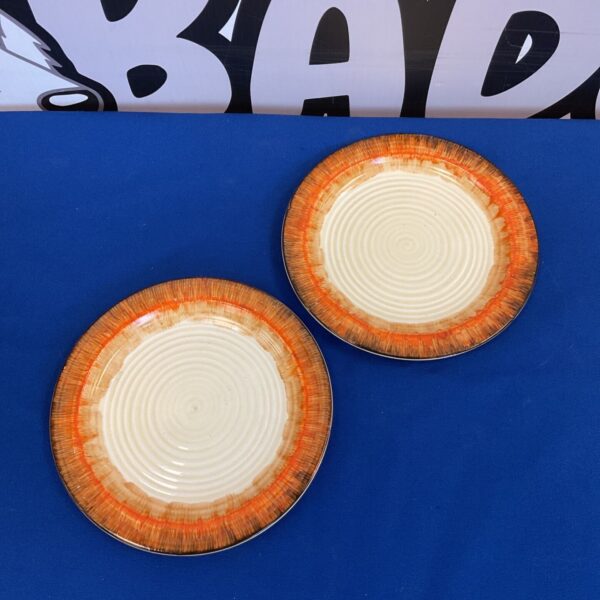 Pair of vintage Clarice Cliff Bizarre plates with orange detailing.