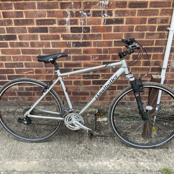 Silver Claud Butler Urban 300 hybrid bike with front suspension.