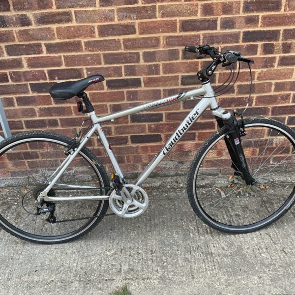 Silver Claud Butler Urban 300 hybrid bike with front suspension.