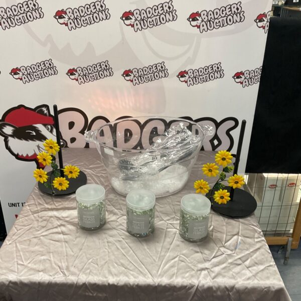 Clear plastic ice bucket with metal towel holders and glass beads.