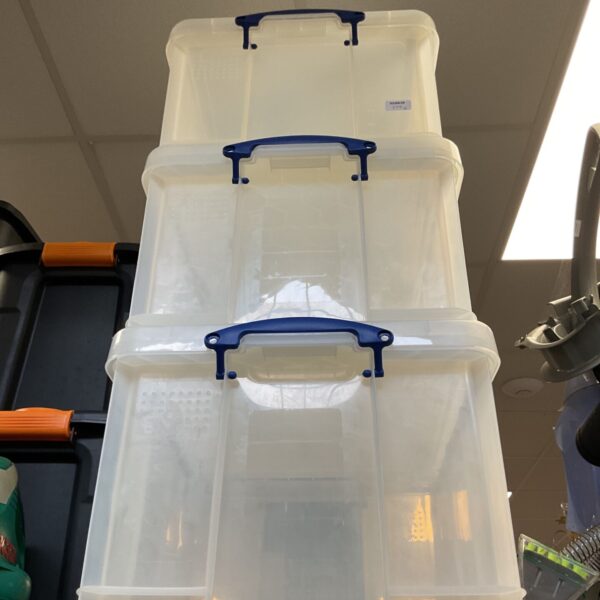 Clear stackable storage boxes for home organization.