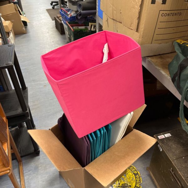 Assorted colourful collapsible fabric storage boxes for home organisation.