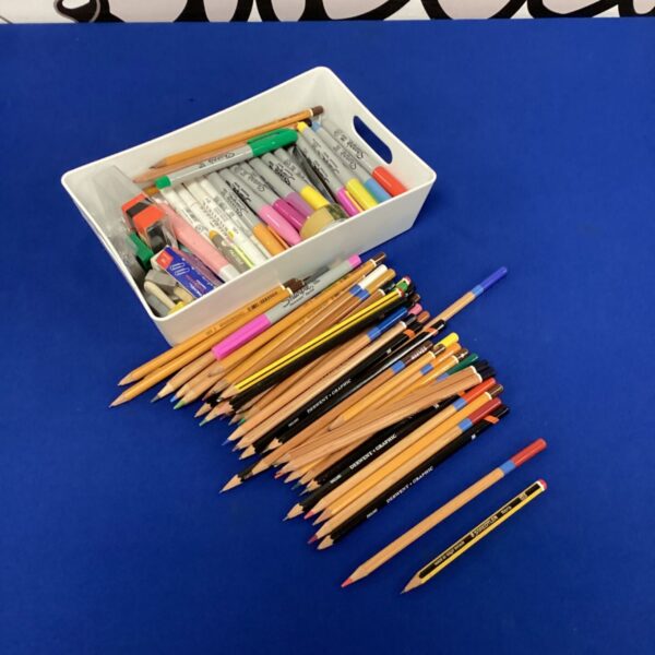 Lot of colourful colouring pens and pencils in a tub.