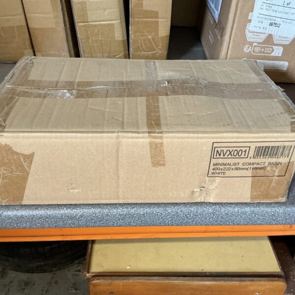 White compact basin in original packaging, model NVX001.