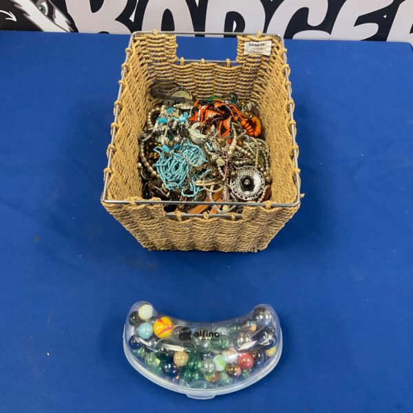 Costume jewellery and marbles lot in a woven basket.