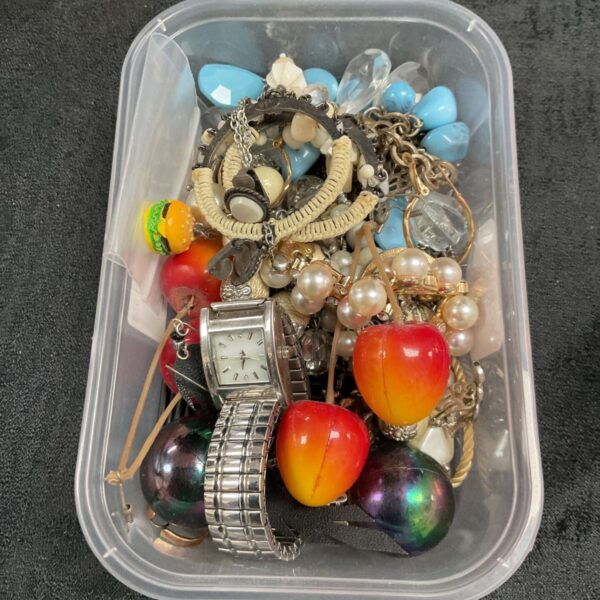 Mixed lot of vintage and costume jewellery on display.