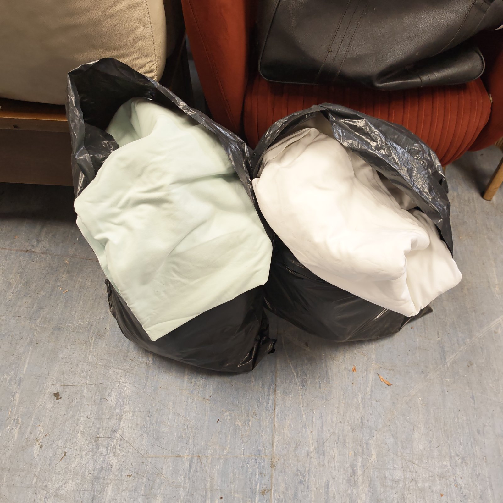 Mixed cotton linen fabric lot in plastic bags.