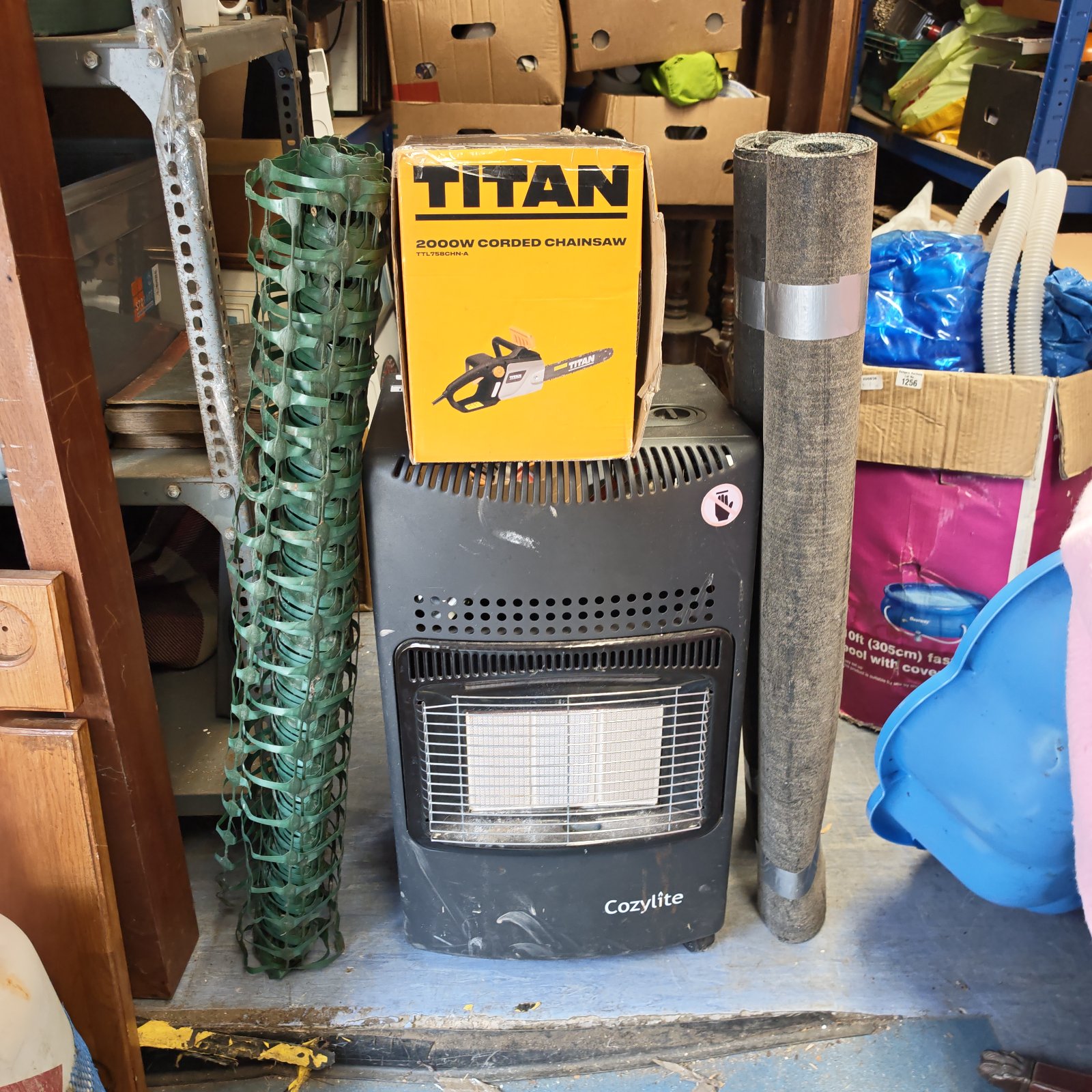 Cozylite gas heater and Titan chainsaw lot for garden and DIY use.