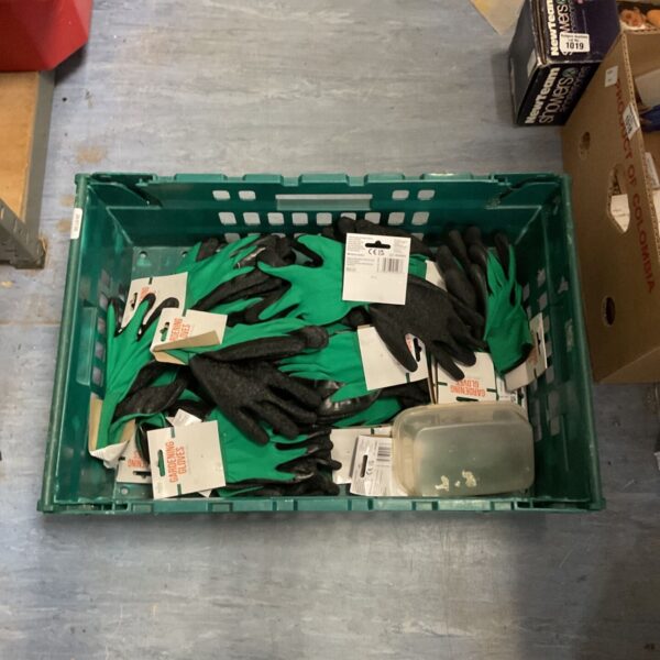 Crate filled with various gardening gloves for outdoor work.