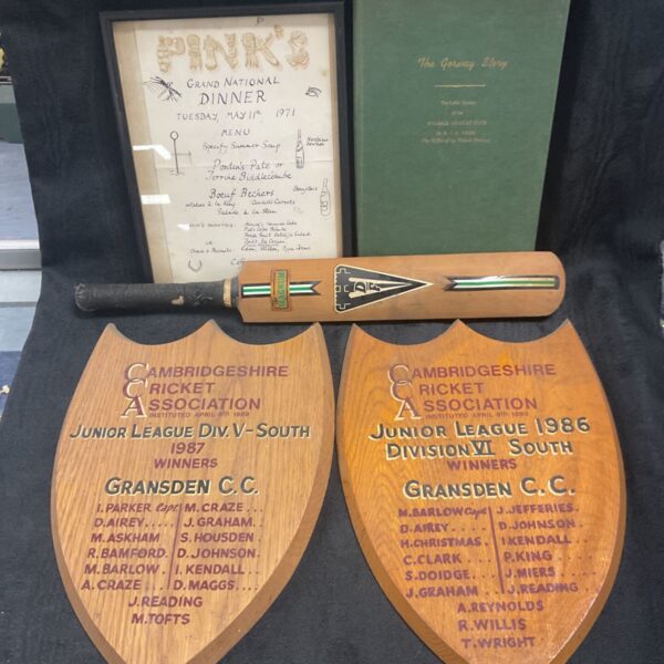 Vintage cricket memorabilia collection including signed bats and book.