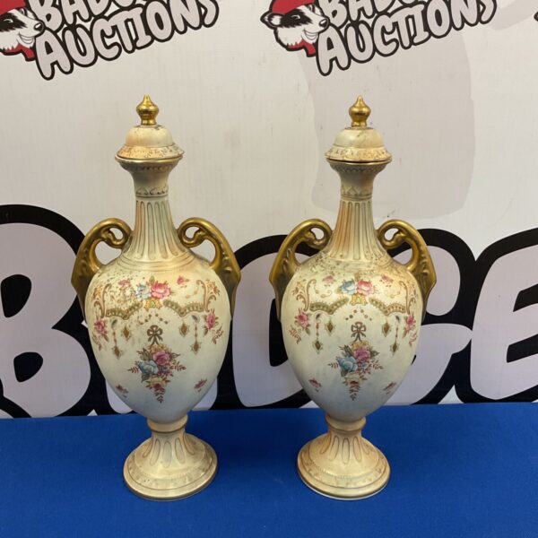 Pair of antique Crown Devon Fieldings lidded urns with floral design.