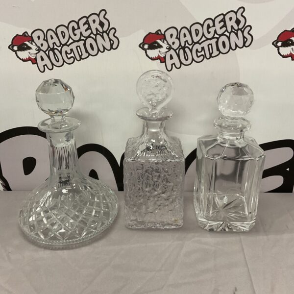 Three vintage crystal decanters including a ships decanter.