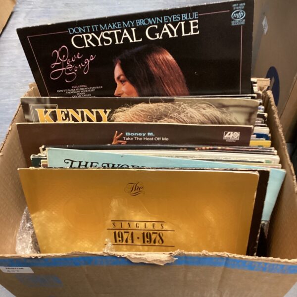Vintage vinyl record collection featuring Crystal Gayle album cover.