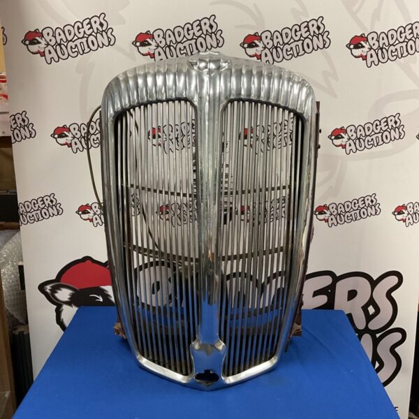 Front view of a vintage Daimler Consort chrome grill.
