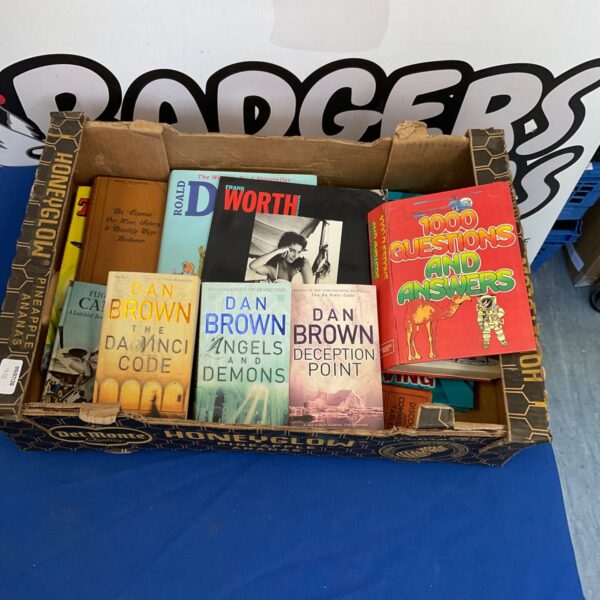 A stack of Dan Brown novels including Angels & Demons and The Da Vinci Code.