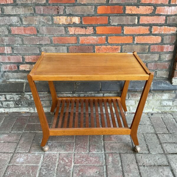 Vintage Danish teak serving trolley with two shelves.