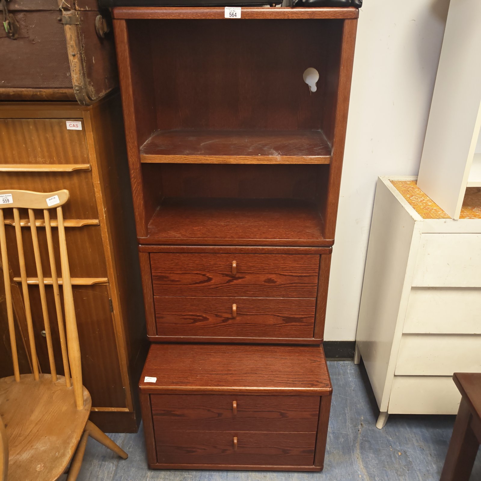 Dark wood shelving unit with drawers for home storage and display.